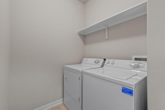 washroom featuring light tile patterned flooring and independent washer and dryer