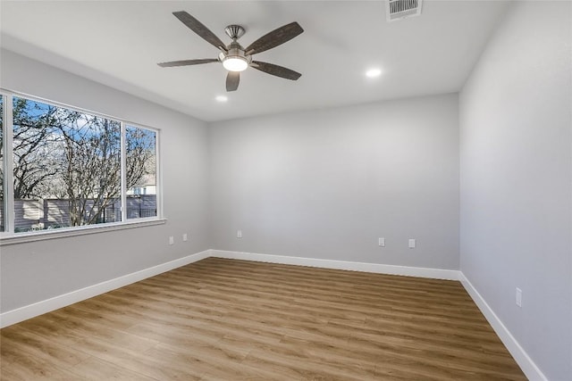 unfurnished room with ceiling fan and light wood-type flooring