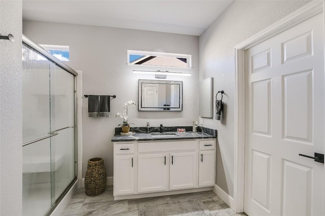 219 Red Poppy Trl, Georgetown, TX 78633 - bathroom featuring vanity, a shower stall, a textured wall, baseboards, and marble finish floors