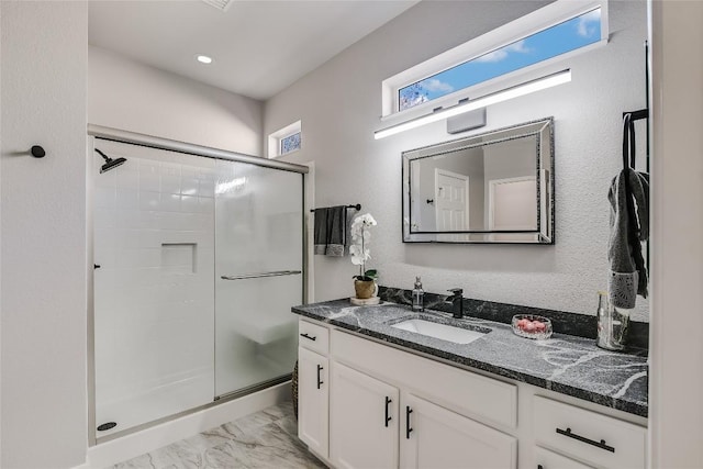 219 Red Poppy Trl, Georgetown, TX 78633 - bathroom with a shower stall, vanity, and marble look tile flooring