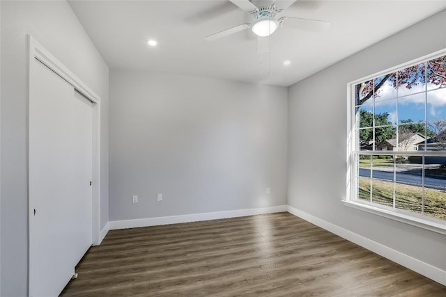 spare room with ceiling fan and dark hardwood / wood-style flooring