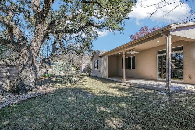 view of yard with ceiling fan and a patio area