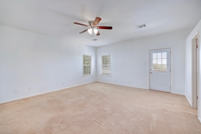 carpeted spare room with ceiling fan