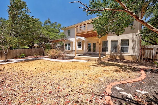 back of house with french doors and a deck