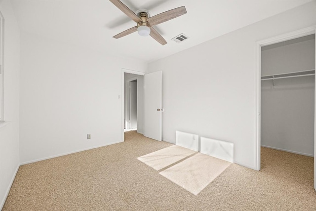 unfurnished bedroom with light carpet, a closet, and ceiling fan