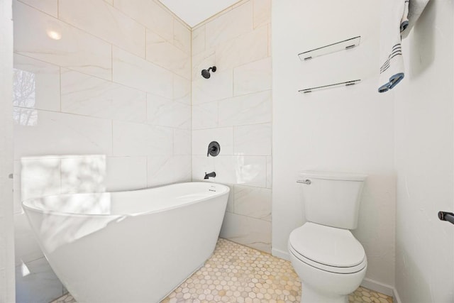 bathroom with tile patterned floors, toilet, tile walls, and a bathing tub