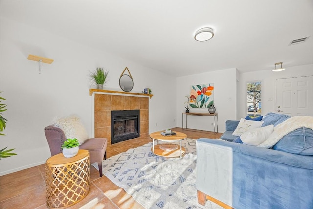 tiled living room featuring a tile fireplace