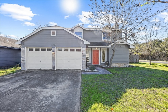 view of front of home with a garage and a front lawn