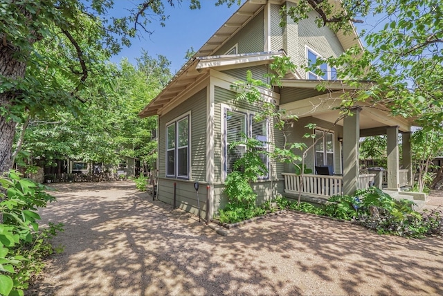 view of side of property featuring a porch