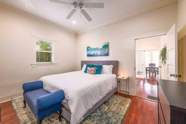 bedroom with ceiling fan, dark hardwood / wood-style floors, and crown molding