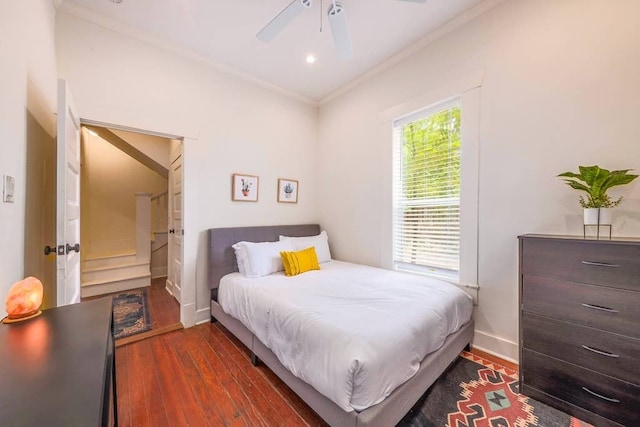 bedroom featuring ceiling fan, dark hardwood / wood-style flooring, and crown molding