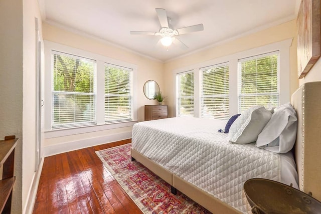 bedroom featuring ceiling fan, dark wood-type flooring, and crown molding