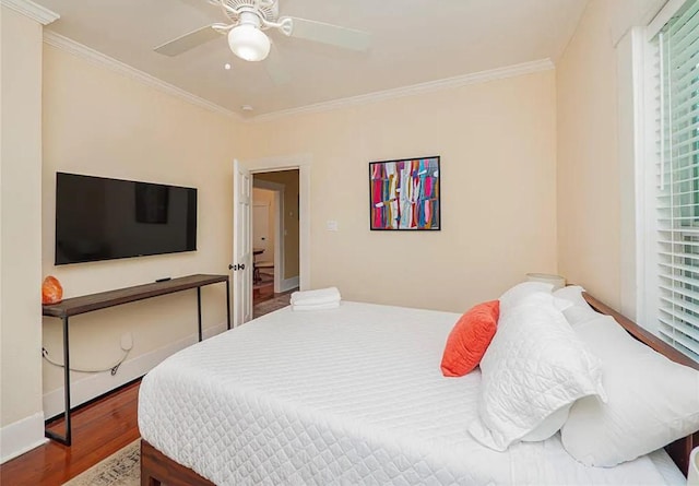 bedroom with ceiling fan, crown molding, and wood-type flooring