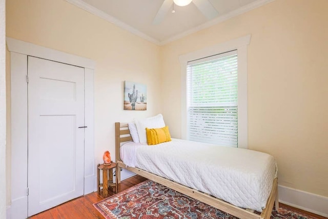 bedroom featuring ceiling fan, hardwood / wood-style floors, and ornamental molding