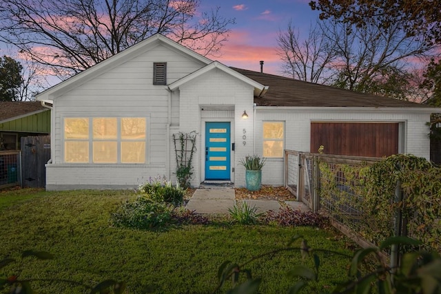 ranch-style house featuring a lawn