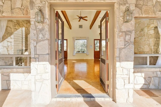 hall with lofted ceiling with beams and light tile patterned floors