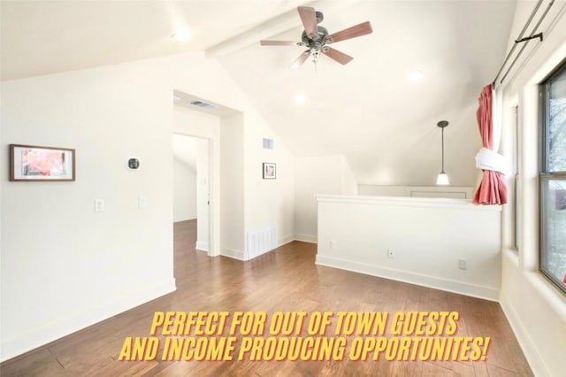 interior space featuring lofted ceiling with beams, ceiling fan, and wood-type flooring