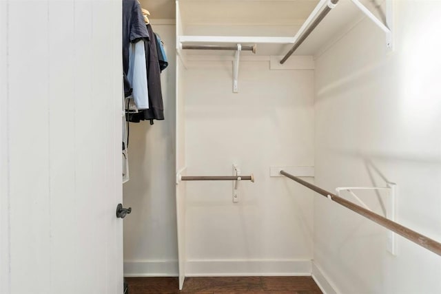 spacious closet with dark wood-type flooring