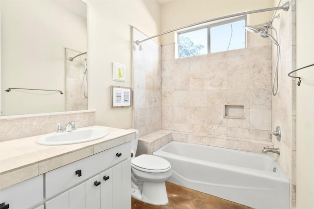 full bathroom with vanity, tiled shower / bath combo, and toilet