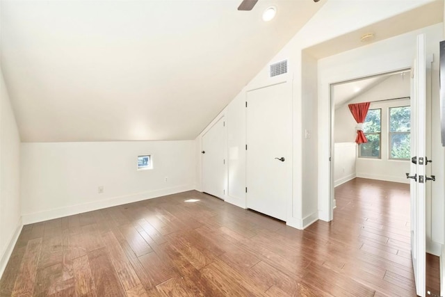 additional living space featuring ceiling fan, dark hardwood / wood-style floors, and lofted ceiling