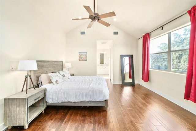 bedroom featuring multiple windows, ceiling fan, ensuite bath, and dark wood-type flooring