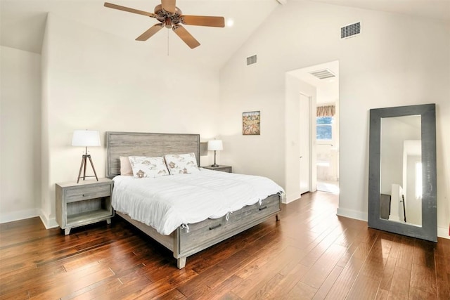 bedroom with ceiling fan, dark wood-type flooring, high vaulted ceiling, and ensuite bath