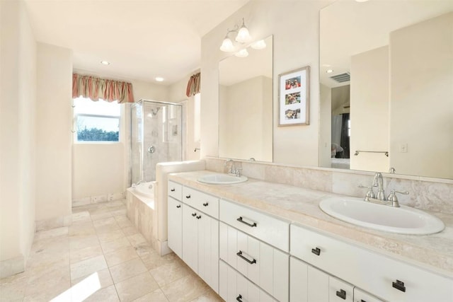 bathroom featuring tile patterned flooring, vanity, and shower with separate bathtub