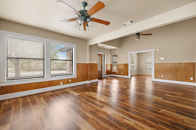 spare room featuring dark hardwood / wood-style flooring, a textured ceiling, and ceiling fan