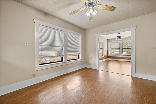 spare room featuring a textured ceiling, hardwood / wood-style flooring, and ceiling fan