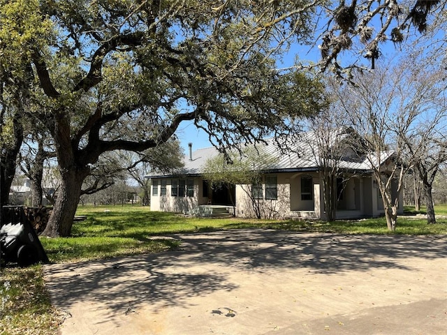 3480 Jack C Hays Trl, Buda, TX 78610 - ranch-style house with stucco siding and a front lawn