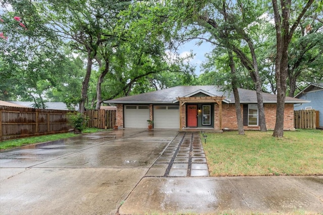 ranch-style house featuring a garage and a front lawn