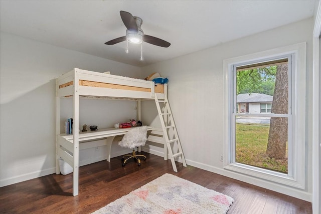 bedroom with ceiling fan and dark wood-type flooring