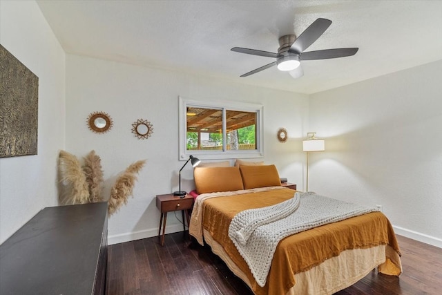 bedroom with ceiling fan and dark wood-type flooring