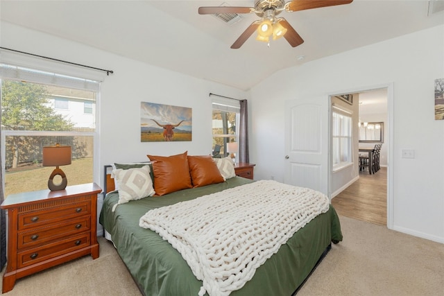 bedroom with multiple windows, ceiling fan, light colored carpet, and lofted ceiling