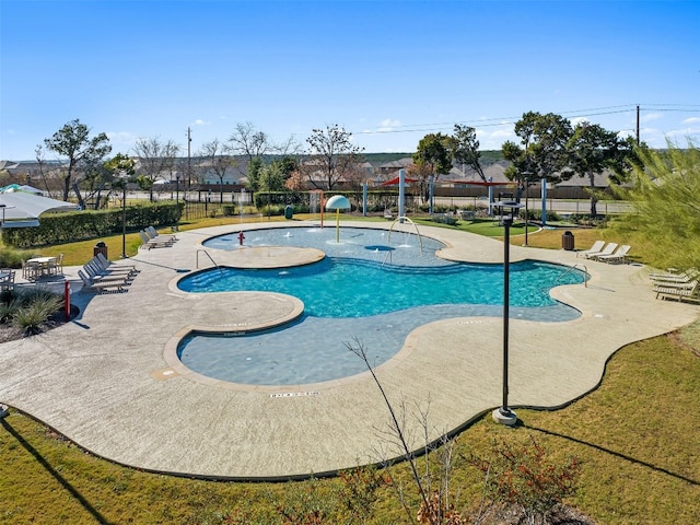 view of swimming pool featuring a lawn, a patio, and pool water feature