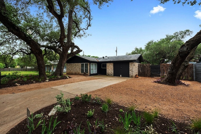 309 Rowland Dr, Austin, TX 78745 - ranch-style home featuring concrete driveway and stone siding