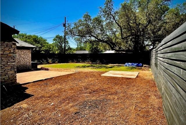 309 Rowland Dr, Austin, TX 78745 - fenced backyard featuring a patio area