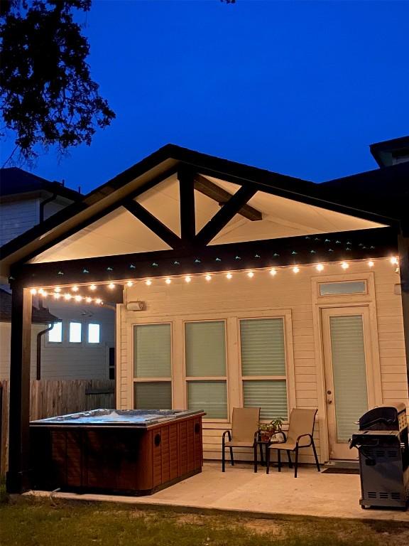 back of house featuring a patio area and a hot tub