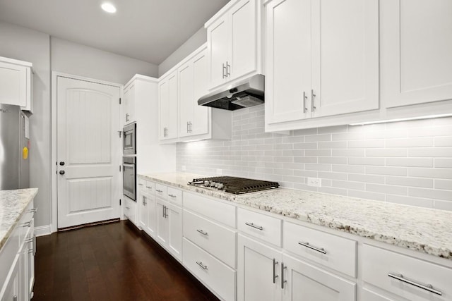 kitchen featuring white cabinetry, light stone counters, and appliances with stainless steel finishes