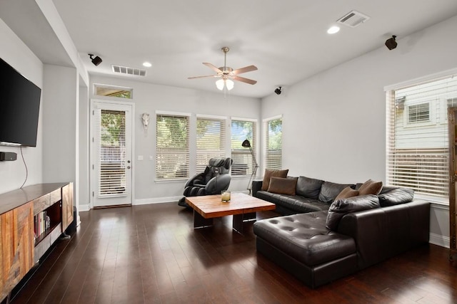 living room featuring ceiling fan and dark wood-type flooring