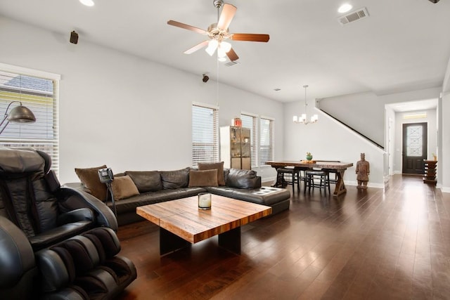 living room featuring ceiling fan with notable chandelier and dark hardwood / wood-style floors