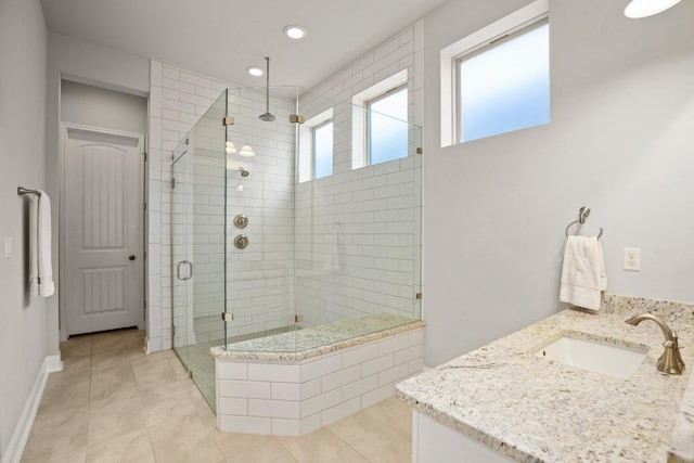 bathroom with tile patterned flooring, vanity, and a shower with shower door