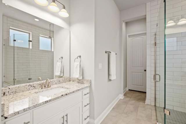 bathroom featuring tile patterned flooring, vanity, and a shower with shower door