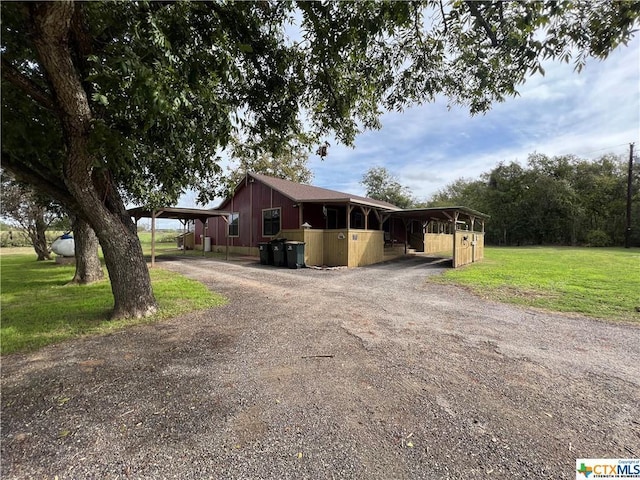 view of front of home featuring an outbuilding and a front lawn