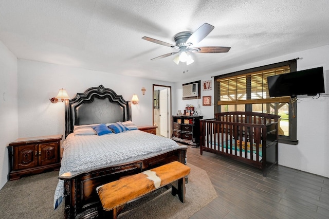 bedroom with ceiling fan and a textured ceiling