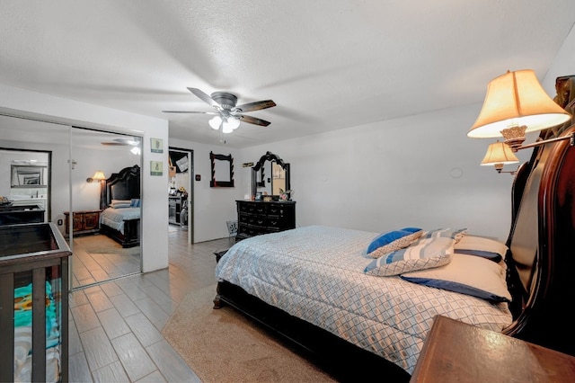 bedroom with ceiling fan and a closet