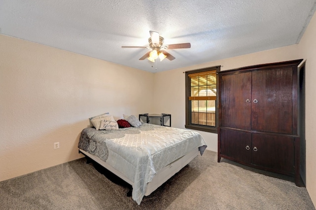 carpeted bedroom with ceiling fan and a textured ceiling