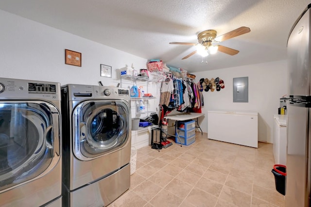 clothes washing area featuring a textured ceiling, electric panel, ceiling fan, and washing machine and dryer