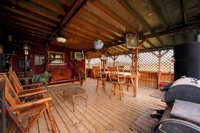 wooden terrace featuring an AC wall unit