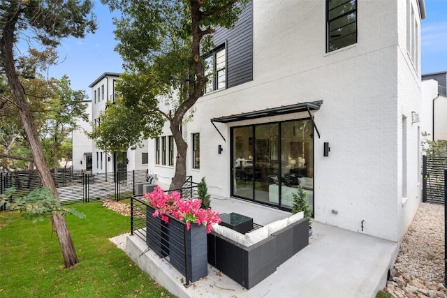 back of house with an outdoor hangout area and a lawn